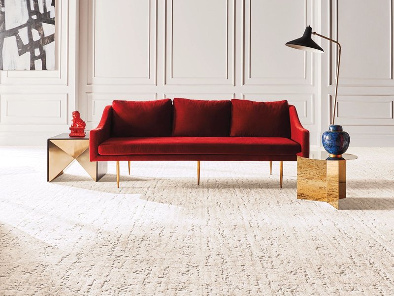 red couch on nylon carpet